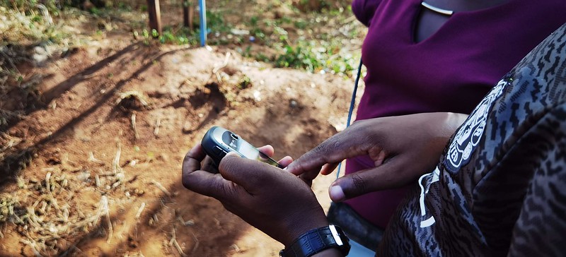 A Youth fellow collecting data using a mobile device during the Kilifi M&E Project